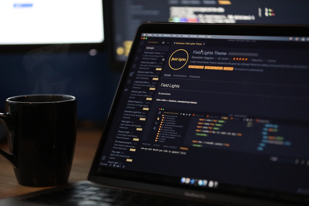 A developer with a laptop and notebook planning code changes in a calm workspace