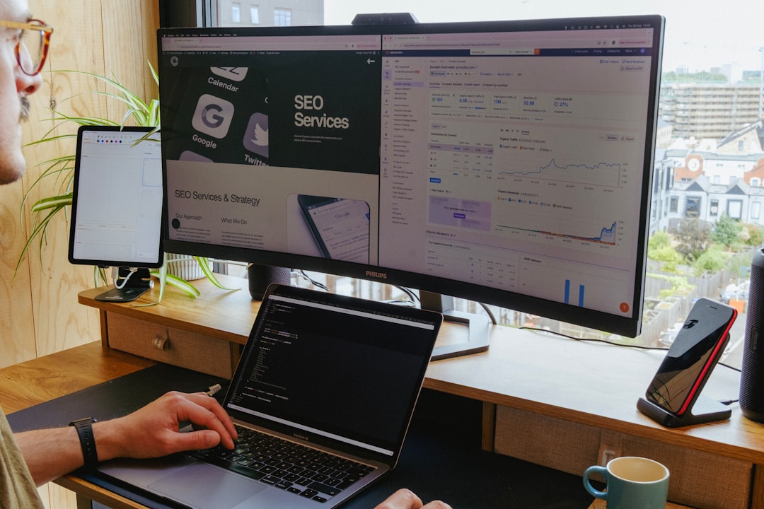 A team reviewing an AI app workflow on a laptop and large monitor with sticky notes nearby