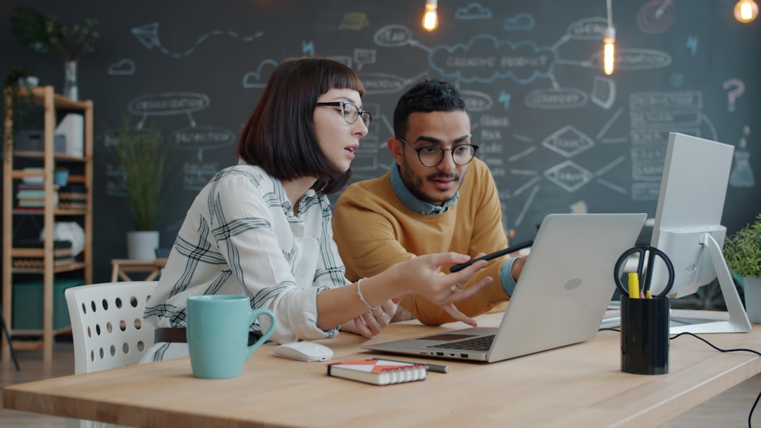 Developer team reviewing event-driven workflow tasks at a workstation