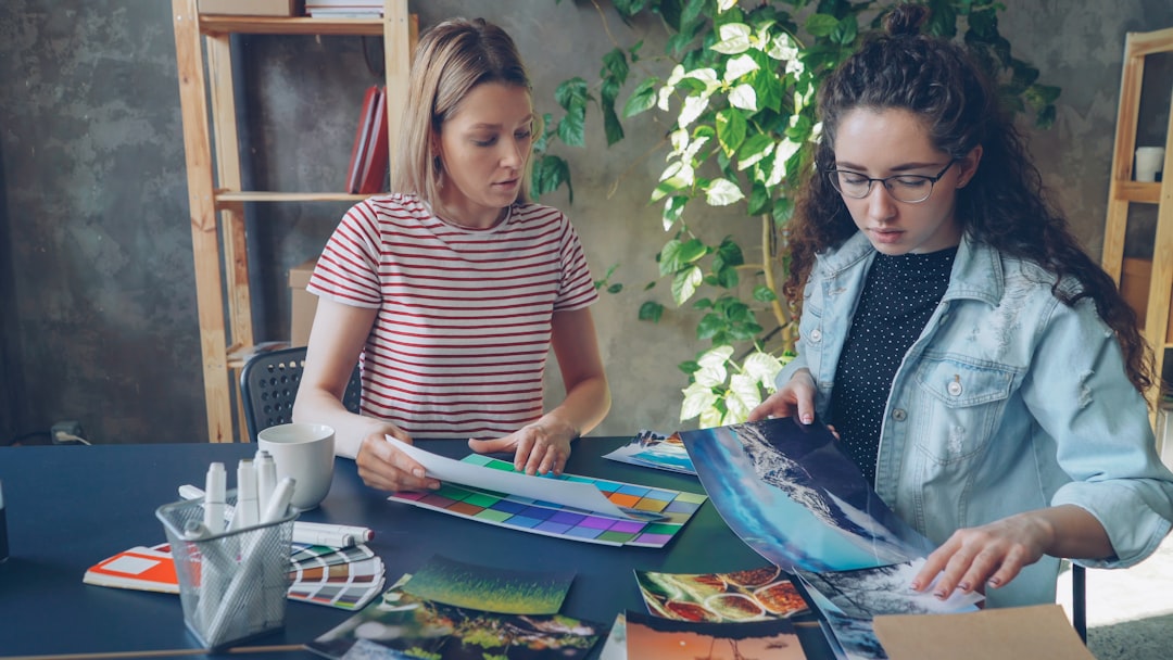 Creator planning social media image crops with product photos and phone mockups on a bright table