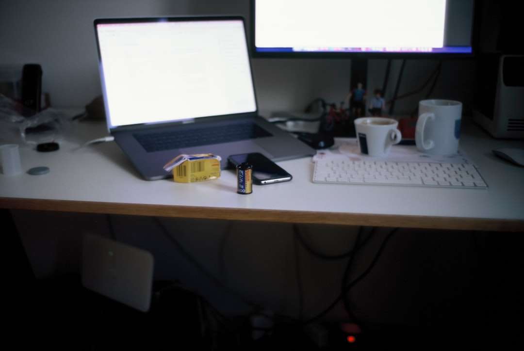 A focused workspace with a laptop and printed documents being prepared for conversion