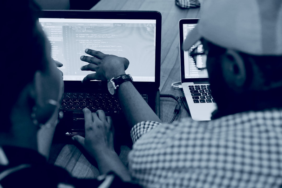 A team reviewing local AI model output on a laptop beside a dashboard and technical notes