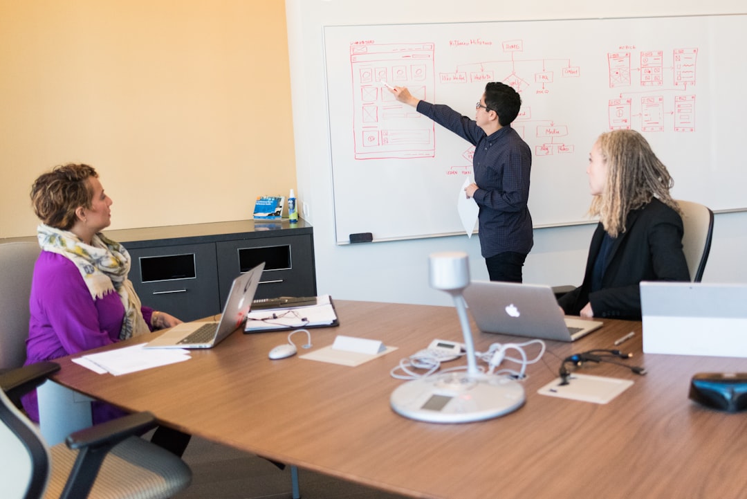 Team planning agent handoffs with a whiteboard and laptop