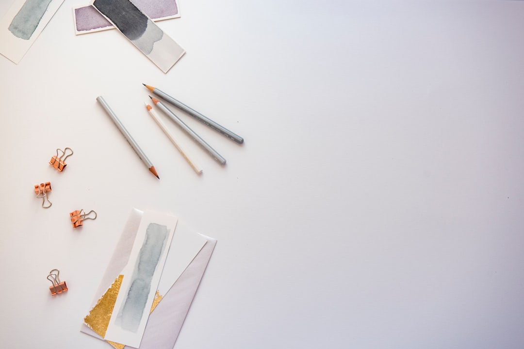 A seller reviewing colorful product photos on a bright table before preparing them for an online store