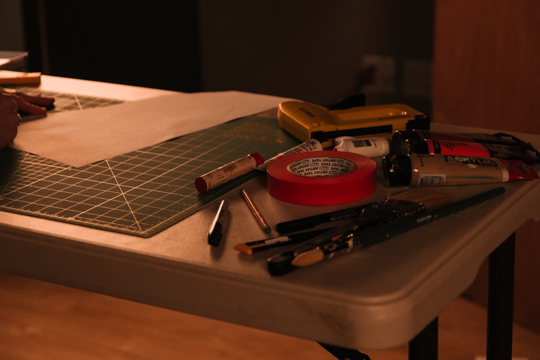 Online seller reviewing product photos at a packing table before preparing images for store listings