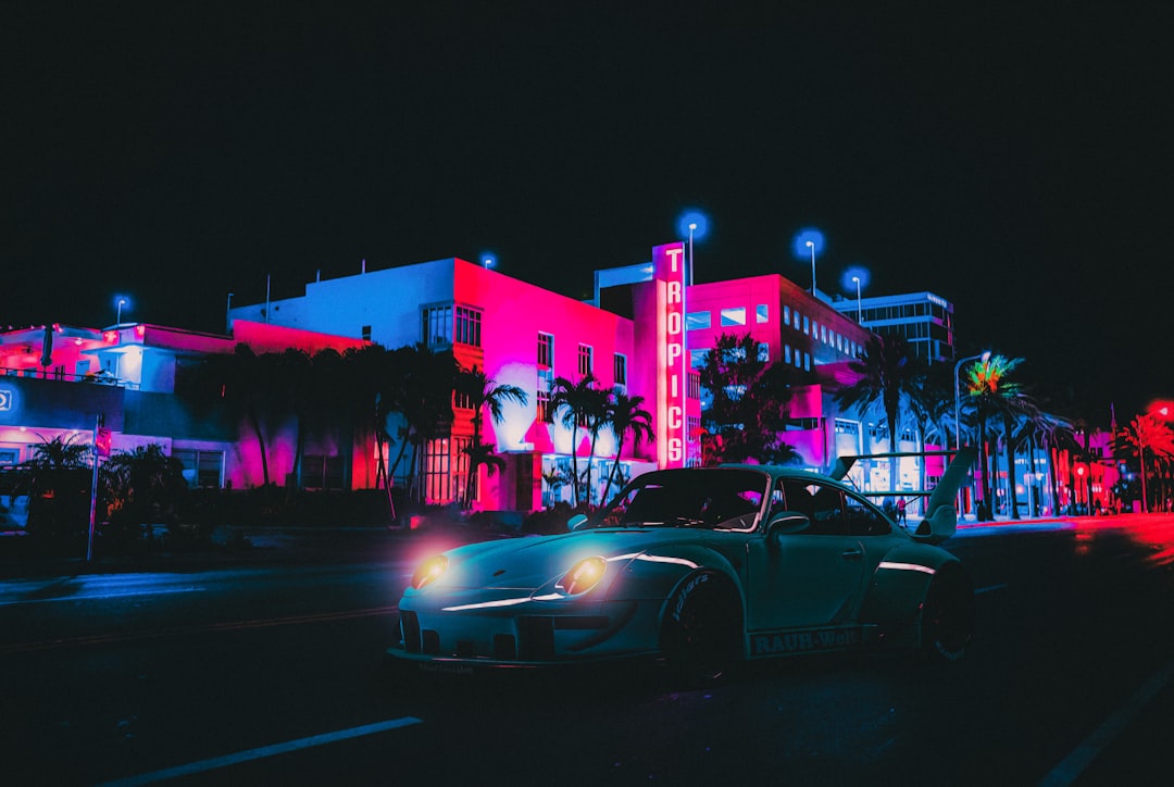 Player running through a neon tropical city street at sunset