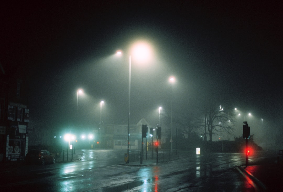 Foggy city street at night in dramatic cinematic light