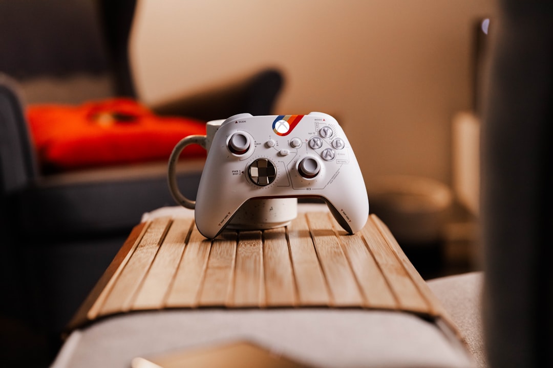 A realistic photo of an Xbox console and controller beside a game controller on a clean desk in natural light