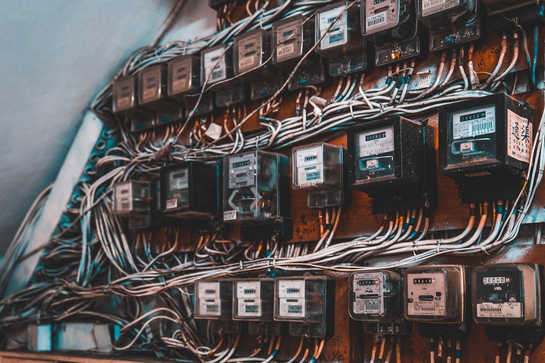 KAIWEETS circuit breaker finder and outlet tester arranged on a clean workbench near a home breaker panel.