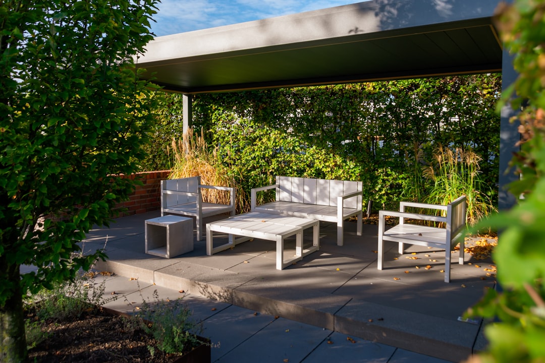 Zero gravity recliner with canopy on a sunny patio corner