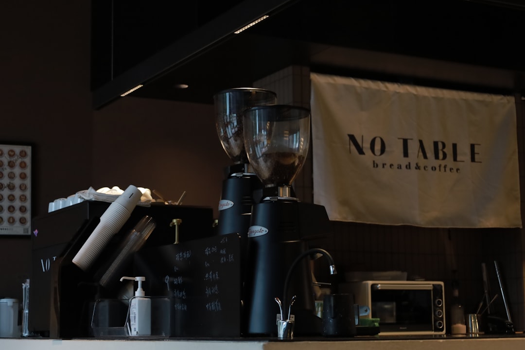 Countertop with milk frother and cocoa setup in a home kitchen