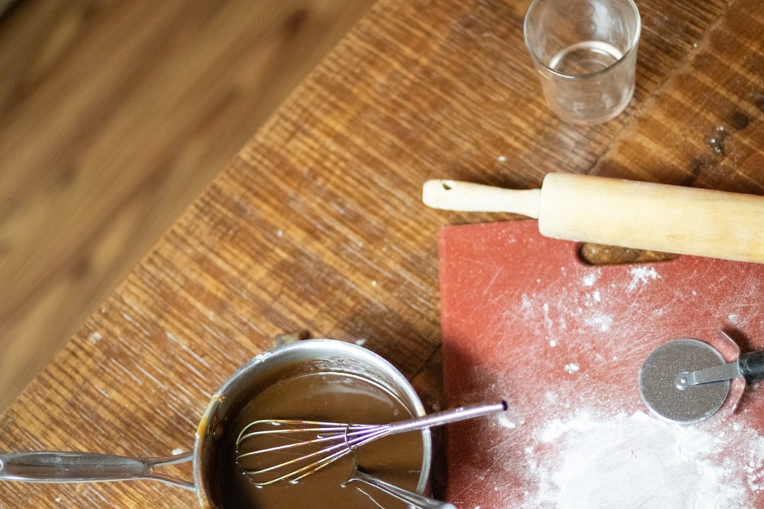 Landscape image of a small dessert counter with a chocolate melter, fondue pot, and cocoa serving station in use.