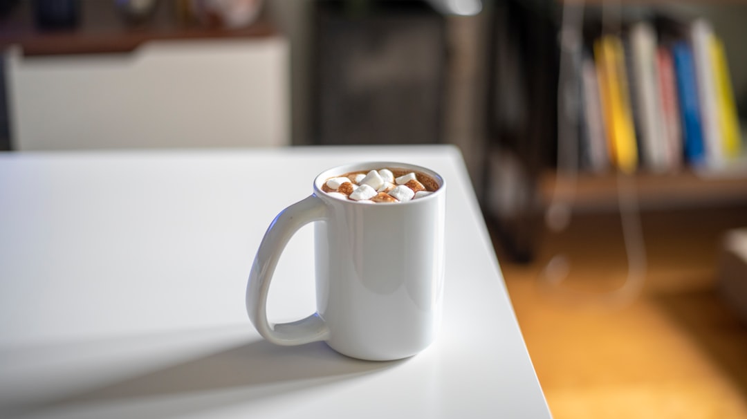 A milk frother and hot chocolate tools arranged on a counter