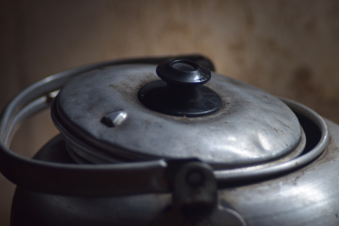 Three temperature-control kettles on a kitchen counter with tea set and espresso cup