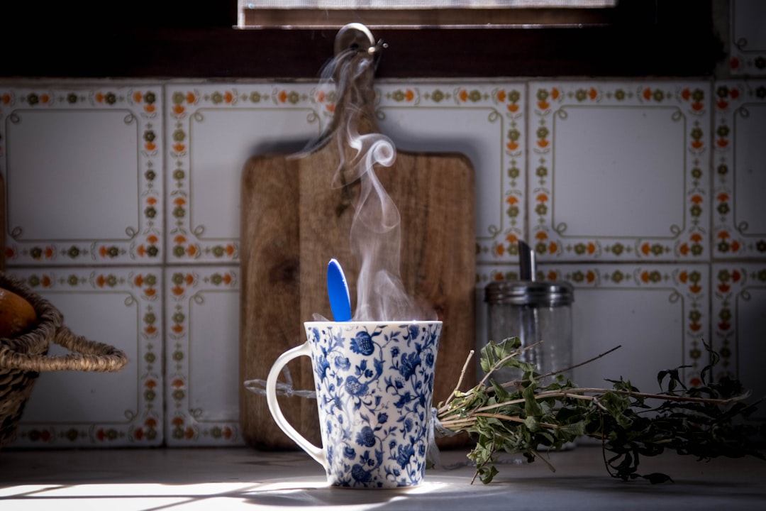 Wide shot of a cozy kitchen counter with cocoa tools and mugs prepared for serving