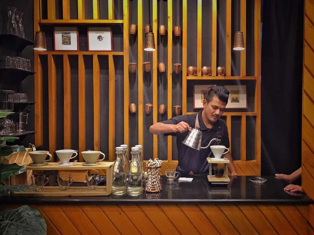A temperature-control kettle and compact milk frother arranged on a clean counter for a small drink routine