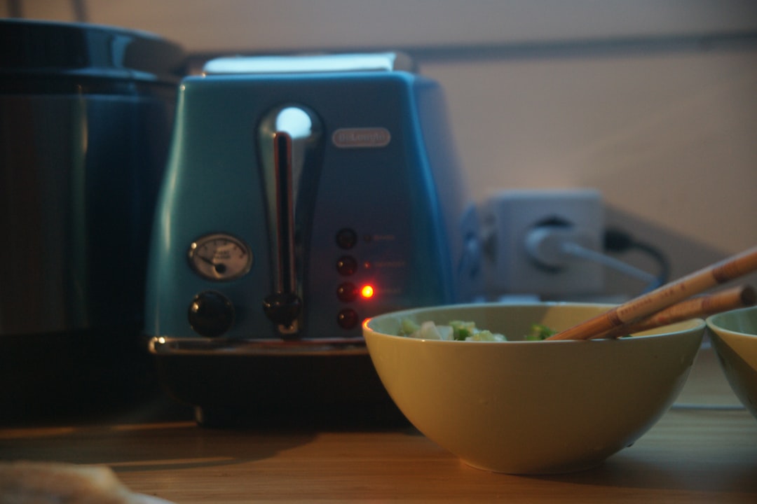 Compact kitchen counter with a hot chocolate maker and electric kettle in a small serving setup