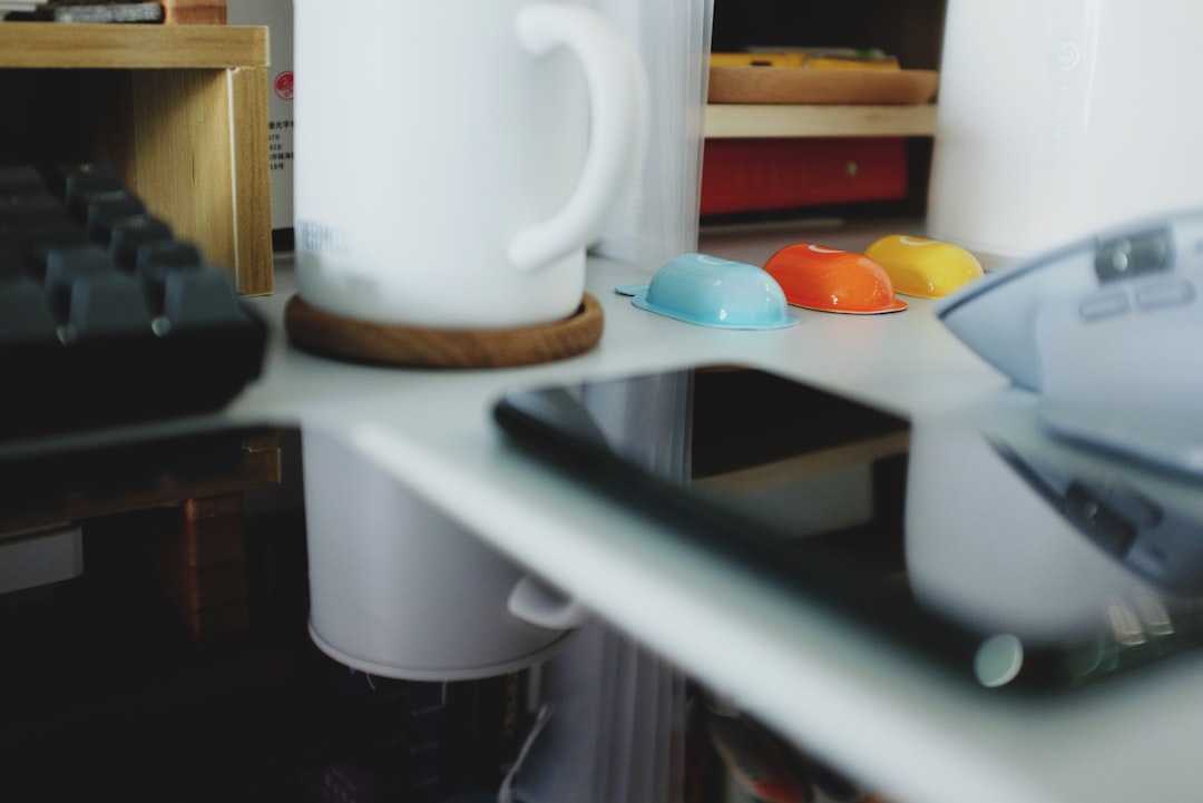 A temperature-control kettle and compact milk frother arranged on a tidy counter for tea and cocoa service