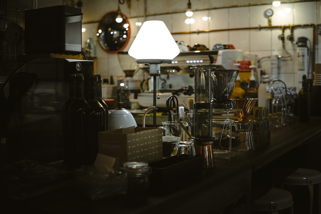 Compact counter setup with kettle, milk frother, and hot chocolate tool during a practical cleanup routine
