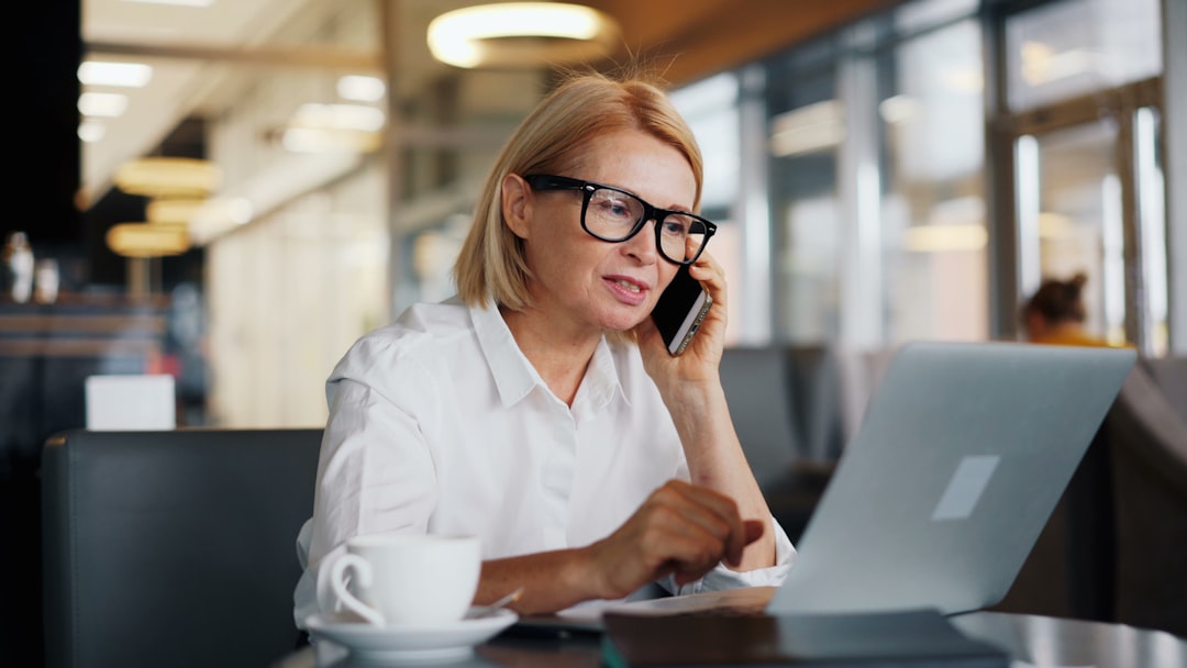 Shop owner checking online business listing details for weekend hours and services