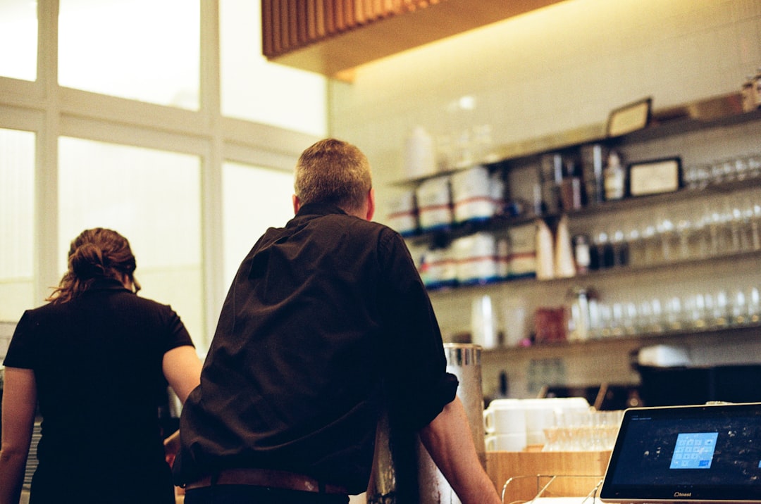 Small business front desk team verifying a customer request with a checklist during a busy shift.