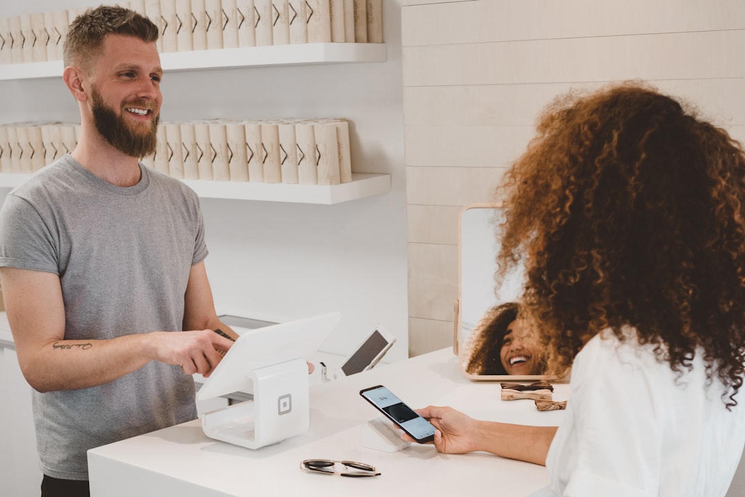 A front desk employee reviewing a customer message draft on a tablet before sending