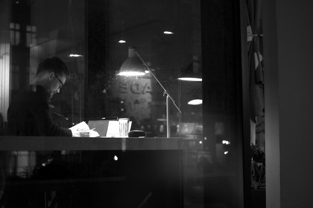 Shop owner reviewing update checklist on phone and laptop
