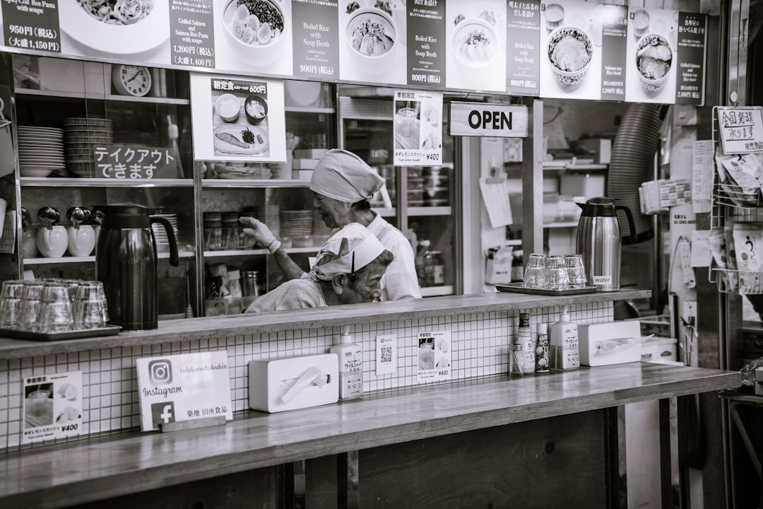 Shop owner and staff reviewing a digital access checklist at the counter